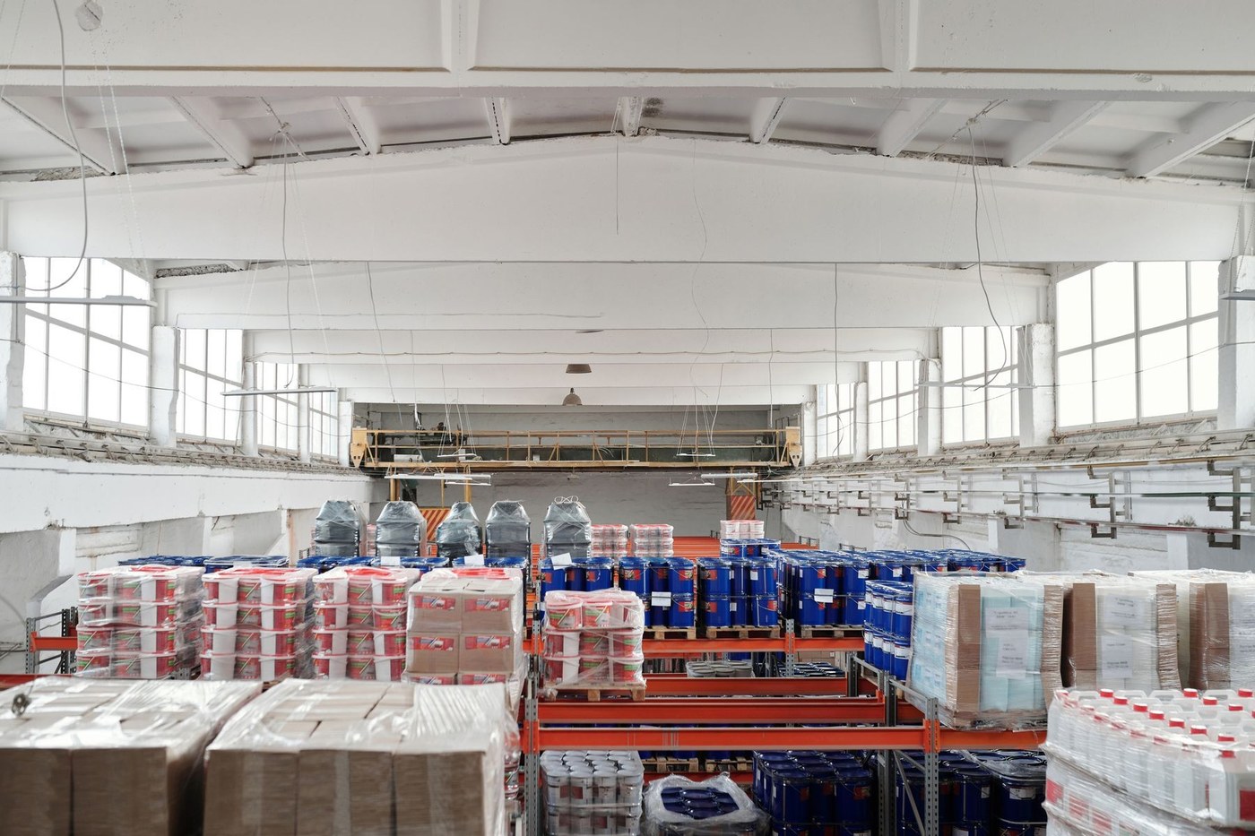 Bright warehouse interior with stocked pallet racks